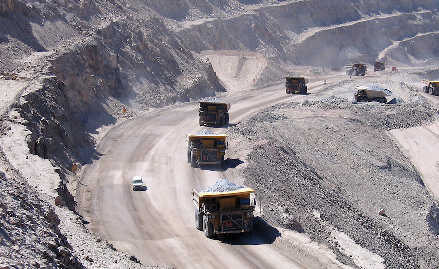 Open-pit haul trucks operating on a mine haul road